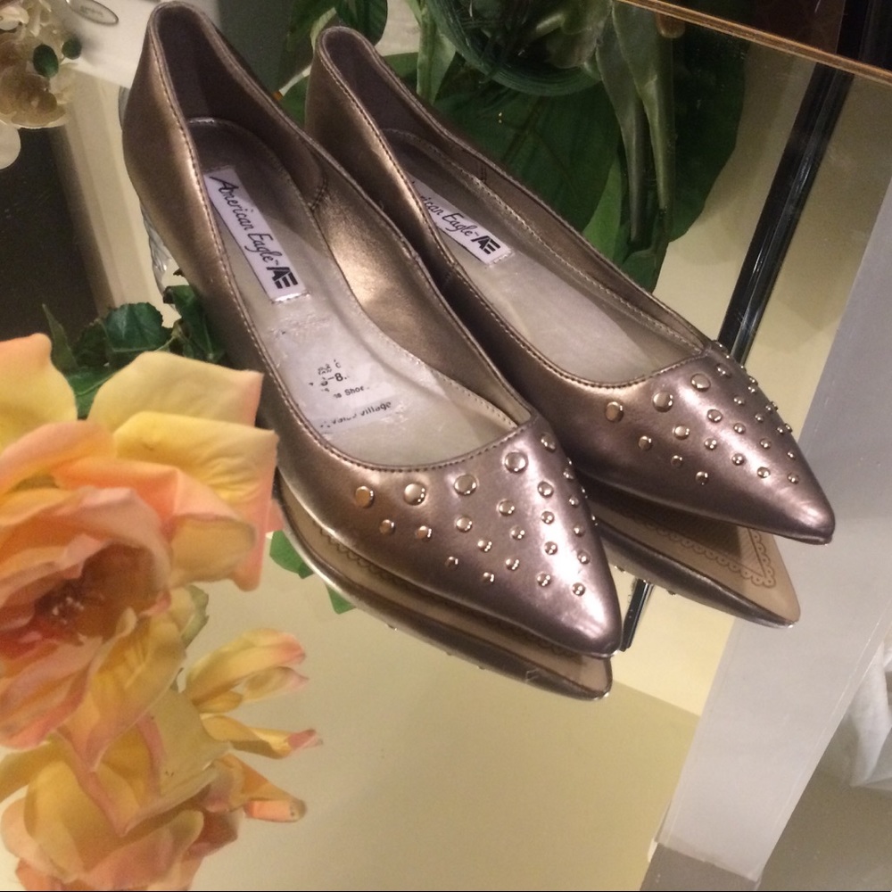 Pointed mustard  gold colored flat heels.